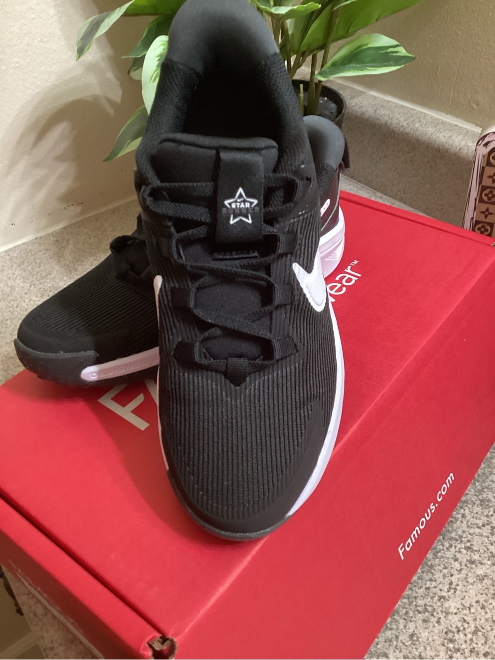 Nike Kids Black and White Star Runner Athletic Sneakers.